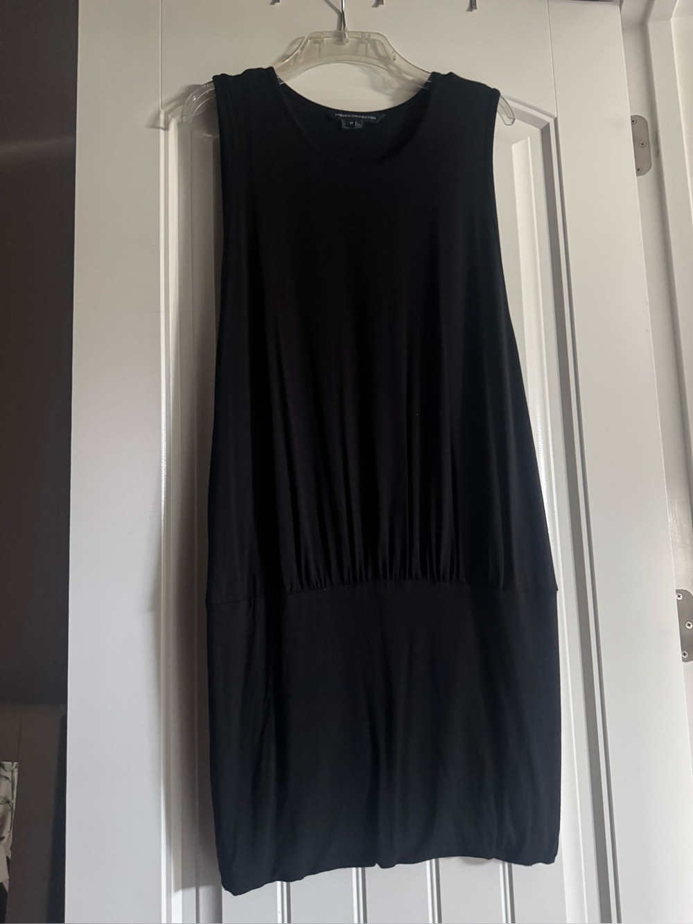 Sleeveless LBD. Mini black t shirt dress fitted at hips